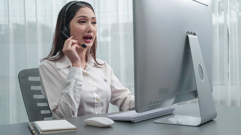 Enthusiastic female operator provide helpful customer service to customer.