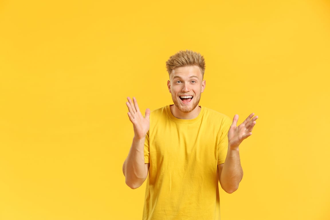 Portrait of Happy Young Man on Color Background