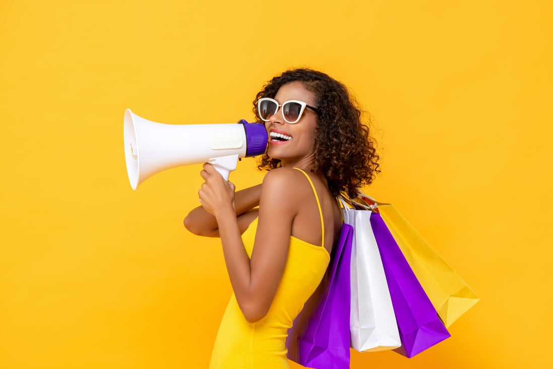 Happy Beautiful Woman with Shopping Bags and Megaphone